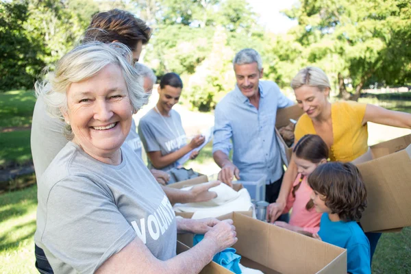 depositphotos_69003967-stock-photo-volunteer-family-separating-donations-stuffs